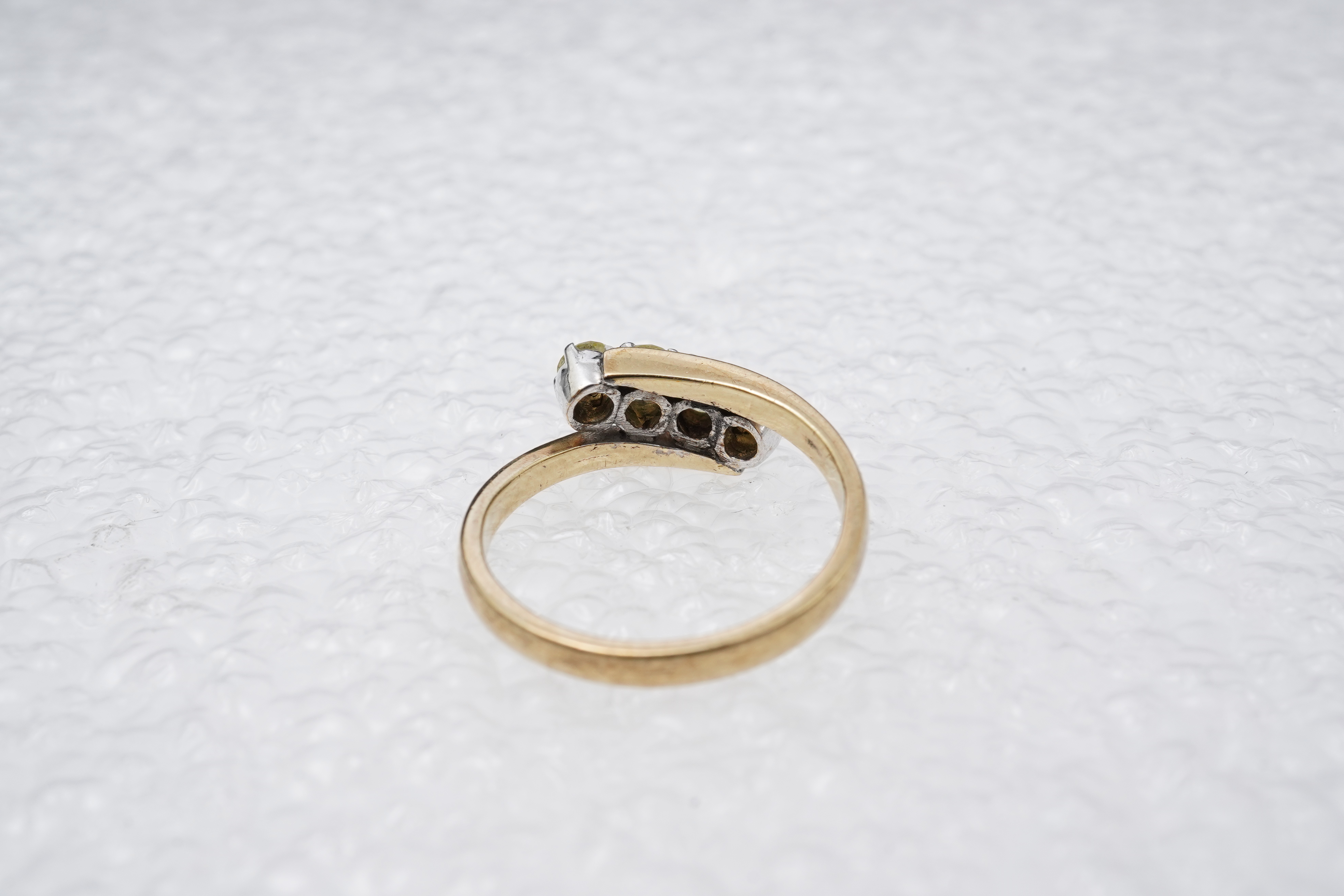 A yellow diamond ring, claw-set with four brilliant-cut diamonds of yellow tint totalling approximately 0.40 carats, mounted in gold, gross weight approximately 2 grams